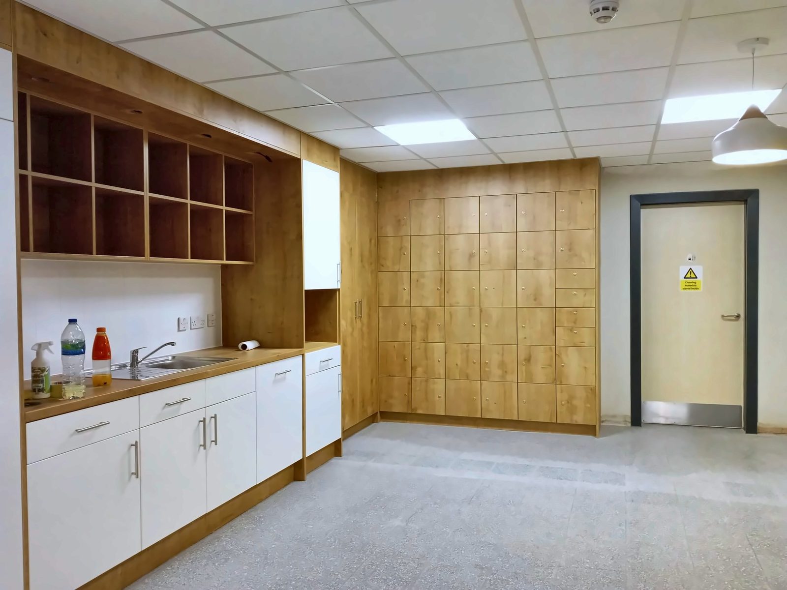 Fitted oak-effect storage wall and kitchenette units