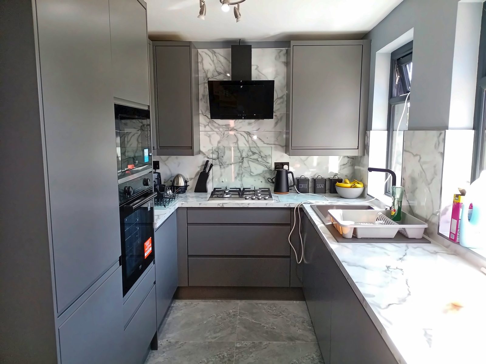 Fitted grey kitchen with marble-effect worktops