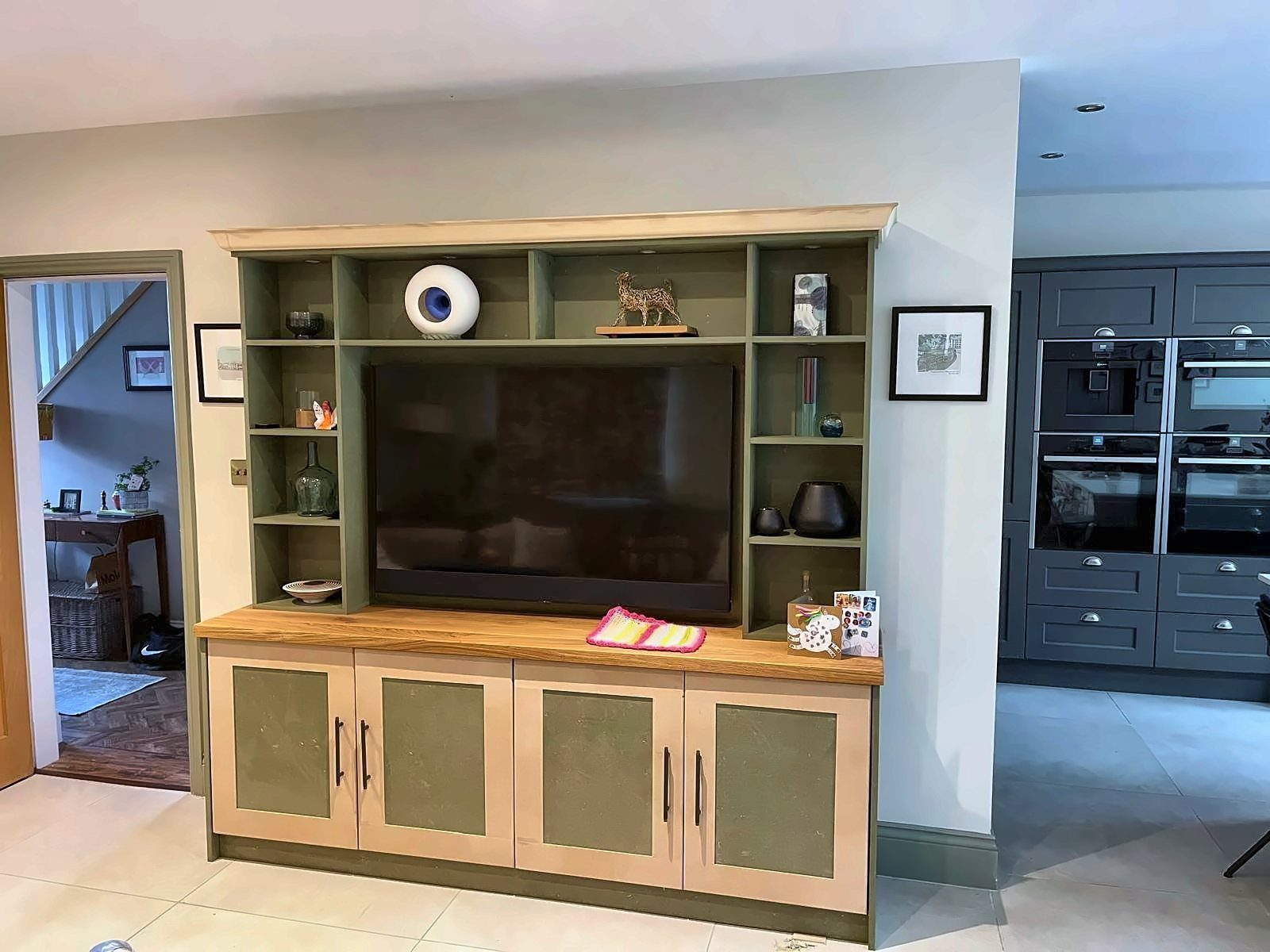 Fitted TV unit with open shelving and cupboards